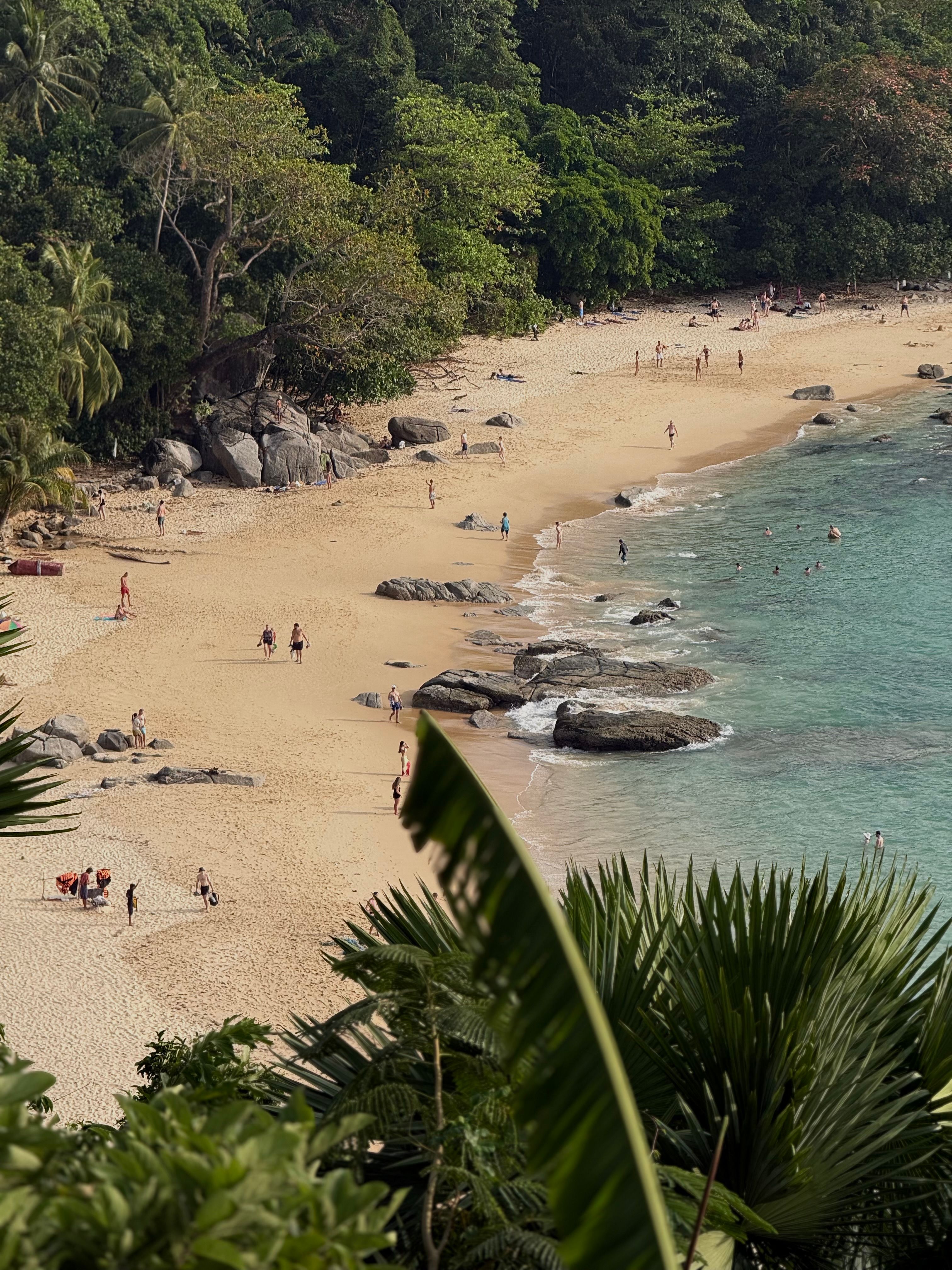 A quiet west-coast Phuket cove with granite boulders and clear water